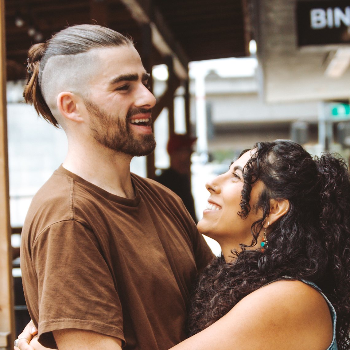 Alex Cunningham and Ivette hugging and laughing outside the studio